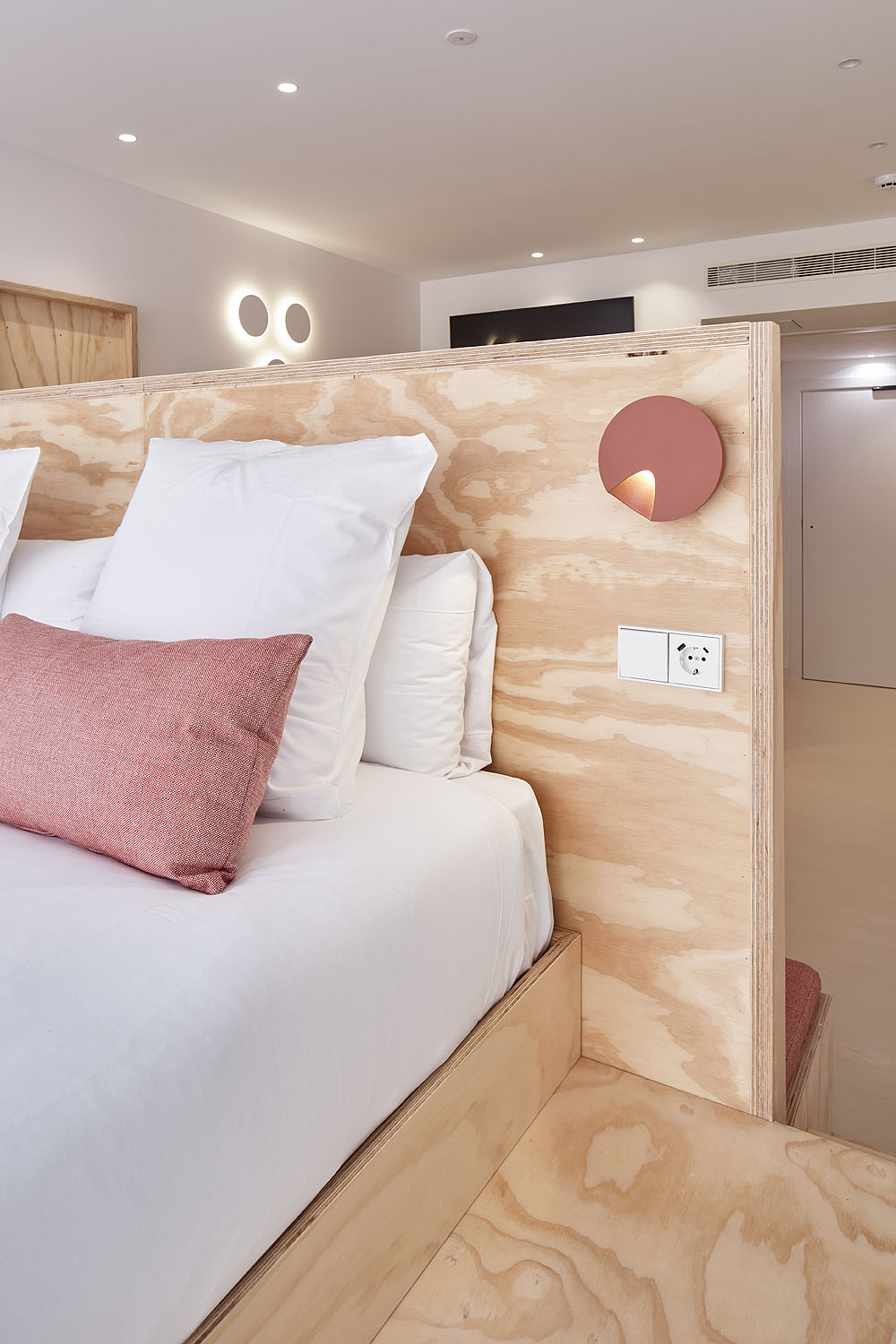 Detalle de la cama y el mobiliario de madera de una Stay Suite en FeelFree STAYS Antiguo.